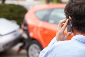 A man calling his lawyer after a Lyft accident in Dallas.