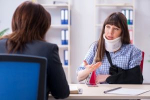 An injured woman discussing with her lawyer about her personal injury case with her attorney in Dallas, Texas. 